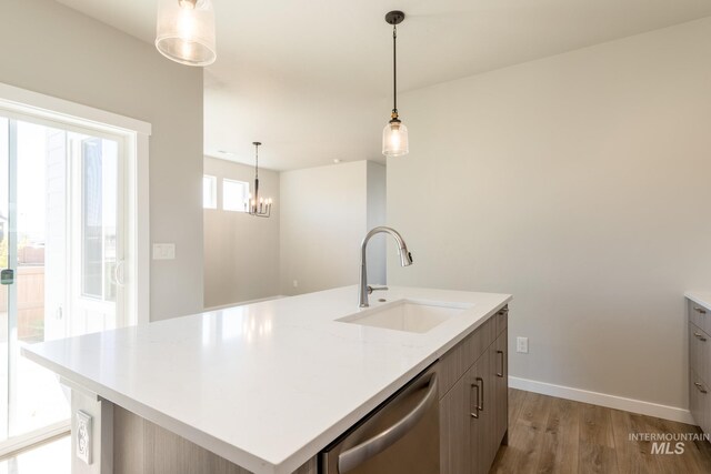 2804 N Eagle Meadow Ave, Kuna, ID 83634 - kitchen featuring a sink, stainless steel dishwasher, light countertops, and light wood finished floors