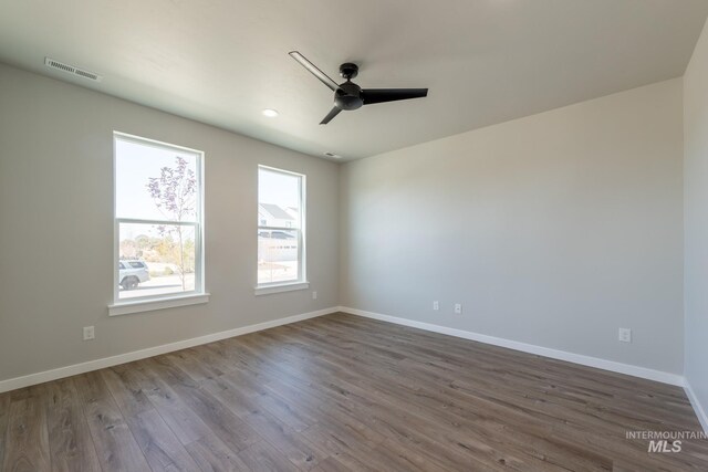 2804 N Eagle Meadow Ave, Kuna, ID 83634 - spare room with visible vents, dark wood-type flooring, ceiling fan, baseboards, and recessed lighting