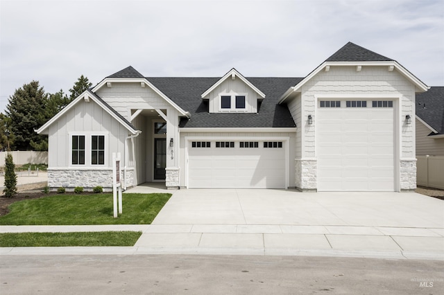 819 Cedar Point Way, Nampa, ID 83686 - view of front facade with stone siding, board and batten siding, a garage, driveway, and roof with shingles
