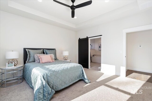 819 Cedar Point Way, Nampa, ID 83686 - carpeted bedroom with a barn door, a ceiling fan, recessed lighting, ensuite bath, and a tray ceiling