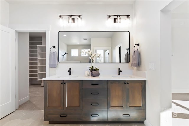819 Cedar Point Way, Nampa, ID 83686 - full bathroom featuring double vanity, tile patterned floors, baseboards, and a spacious closet