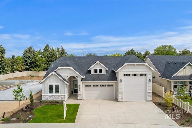 819 Cedar Point Way, Nampa, ID 83686 - view of front facade with stone siding, an attached garage, board and batten siding, driveway, and a shingled roof