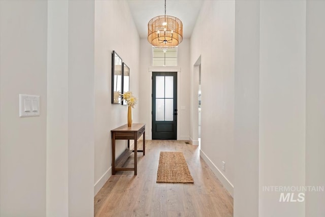 819 Cedar Point Way, Nampa, ID 83686 - entryway featuring light wood-style floors, a chandelier, baseboards, and a towering ceiling