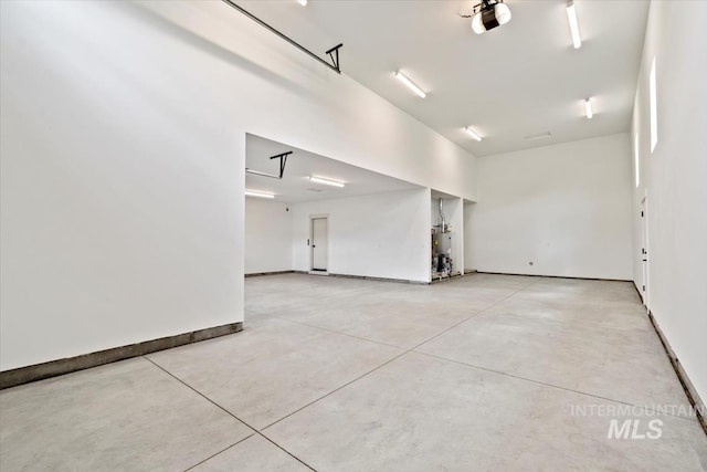 819 Cedar Point Way, Nampa, ID 83686 - garage featuring water heater, baseboards, and a garage door opener