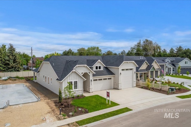 819 Cedar Point Way, Nampa, ID 83686 - view of front facade with board and batten siding, fence, concrete driveway, a residential view, and stone siding