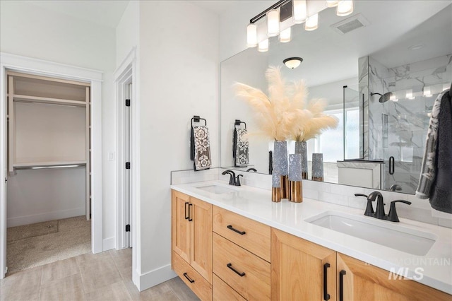 bathroom featuring an enclosed shower and vanity