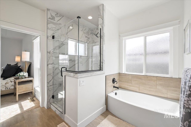 bathroom featuring shower with separate bathtub, wood-type flooring, and a wealth of natural light