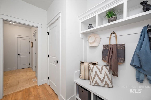 mudroom with wood-type flooring