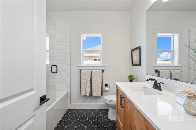 full bathroom featuring toilet, tile patterned flooring, plus walk in shower, and vanity