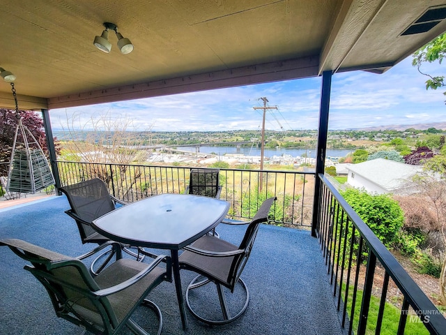 balcony featuring a water view