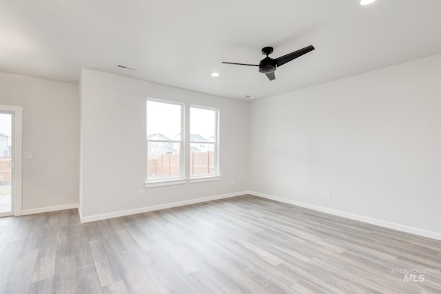 spare room featuring ceiling fan and light wood-type flooring