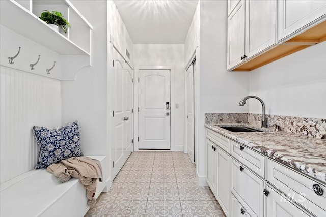 interior space with sink and light tile patterned flooring