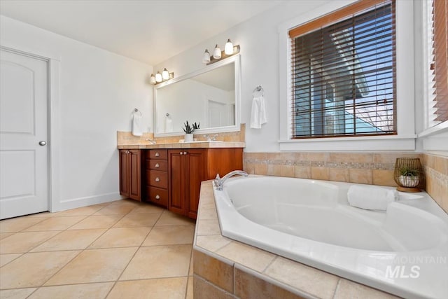 bathroom featuring vanity, tiled bath, and tile patterned floors