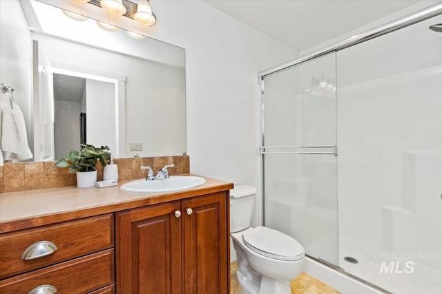 bathroom with toilet, vanity, an enclosed shower, and tile patterned floors