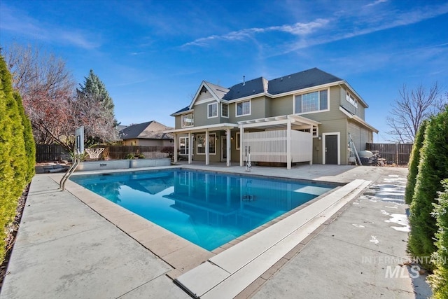 back of house featuring a patio and a fenced in pool