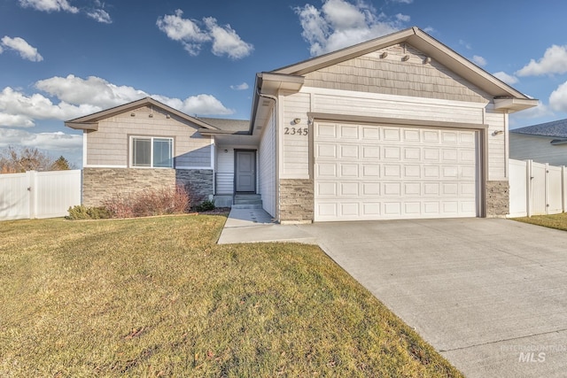 view of front of home featuring a garage and a front lawn