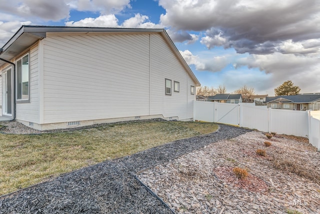 view of property exterior with a lawn