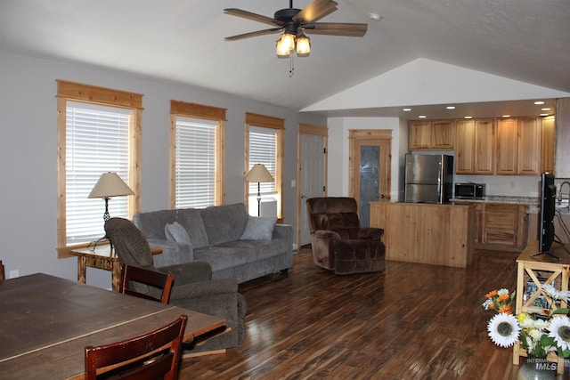 living room with dark wood-type flooring, ceiling fan, and vaulted ceiling