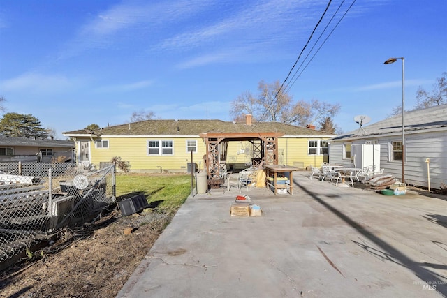 back of property featuring a gazebo and a patio