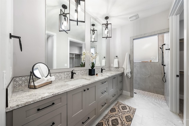 full bath with a walk in closet, double vanity, a sink, and a walk in shower