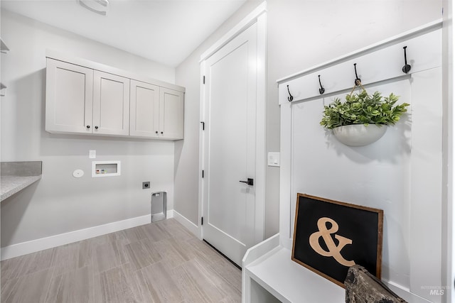 laundry area featuring cabinet space, visible vents, baseboards, hookup for a washing machine, and electric dryer hookup