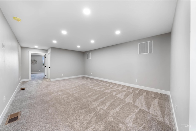 empty room with recessed lighting, visible vents, and light colored carpet