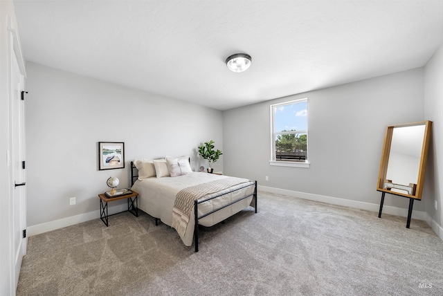 carpeted bedroom with baseboards