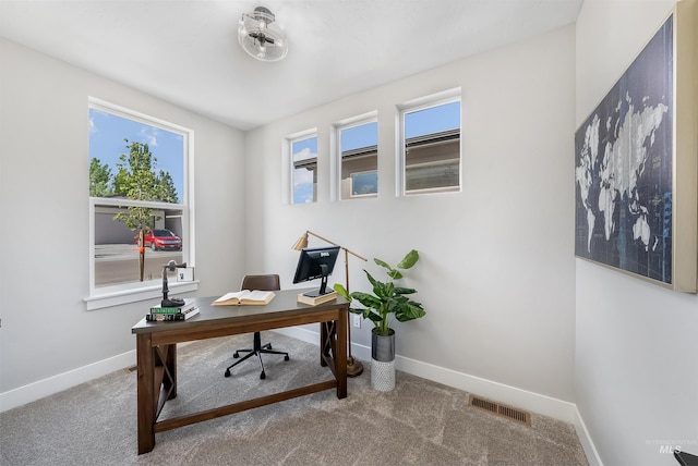 carpeted office with visible vents and baseboards