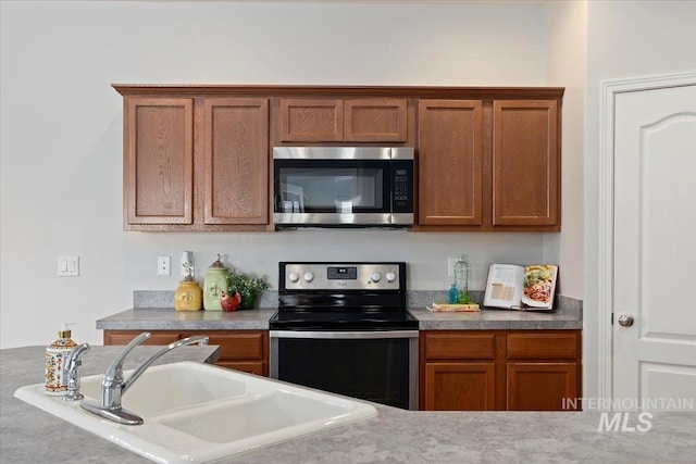 182 New Hampshire Way, Twin Falls, ID 83301 - kitchen featuring appliances with stainless steel finishes, a sink, and brown cabinetry