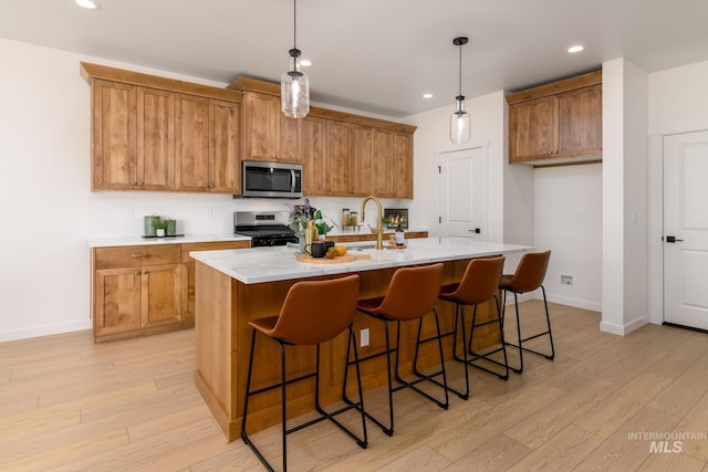 2041 W Gelding St, Middleton, ID 83644 - kitchen with appliances with stainless steel finishes, brown cabinets, light wood-style flooring, and recessed lighting