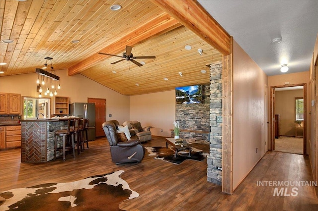 living room with a ceiling fan, wood finished floors, vaulted ceiling with beams, and wooden ceiling
