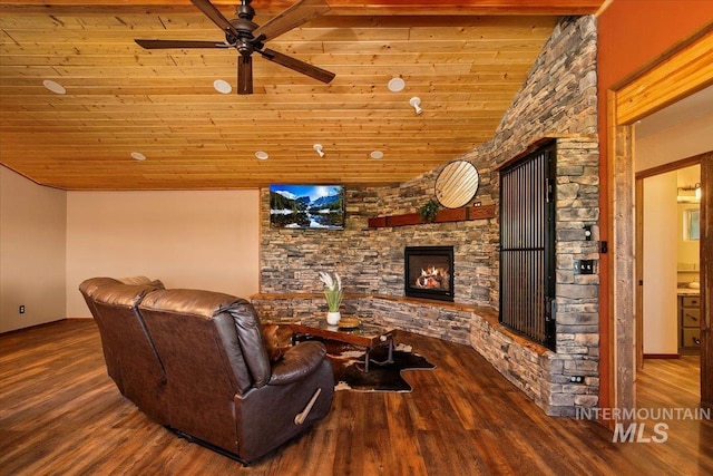 living room with wood ceiling, wood finished floors, ceiling fan, and a fireplace