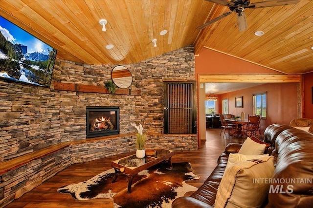 living area featuring ceiling fan, a fireplace, vaulted ceiling, wooden ceiling, and wood finished floors