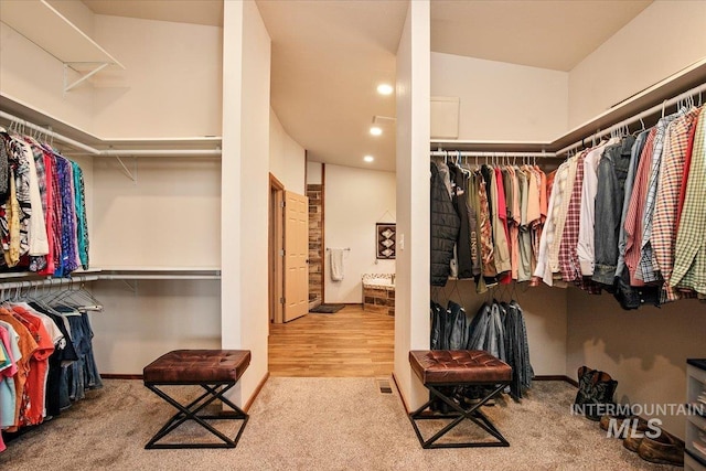 walk in closet with carpet flooring
