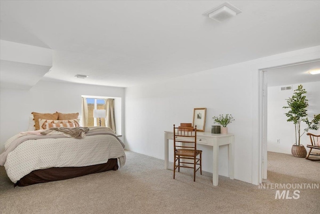 bedroom with visible vents and carpet floors