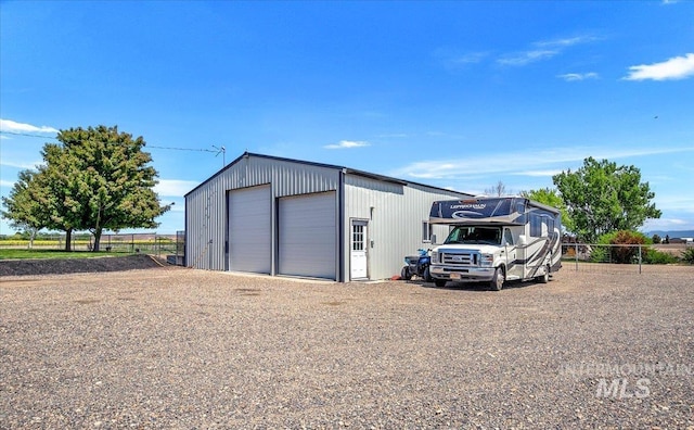 view of outbuilding featuring an outdoor structure and fence