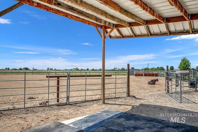 view of yard with an enclosed area and a rural view