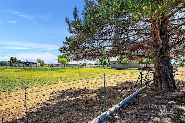 view of yard featuring fence and a rural view