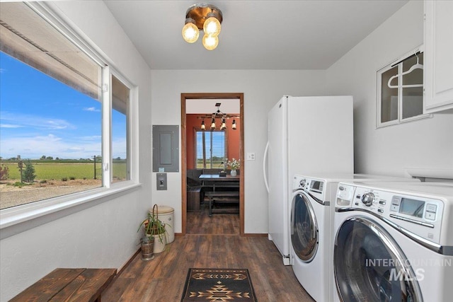 laundry area featuring a chandelier, electric panel, dark wood finished floors, cabinet space, and washer and dryer