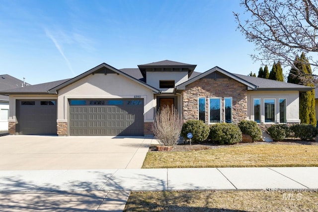 view of front of house with stucco siding, a garage, stone siding, driveway, and a front lawn