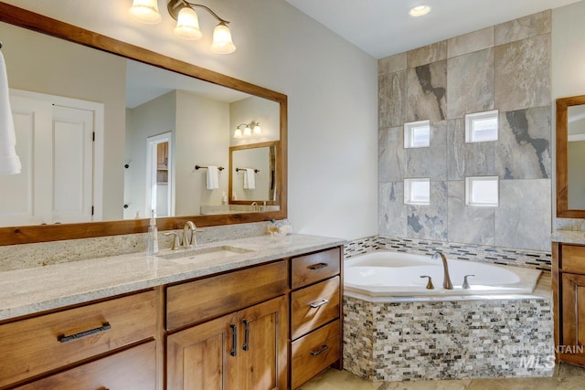 bathroom featuring vanity and a bath