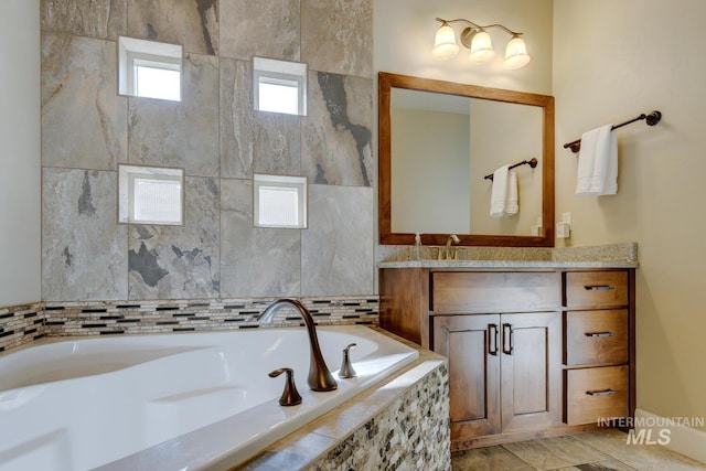 full bathroom featuring vanity and a bath