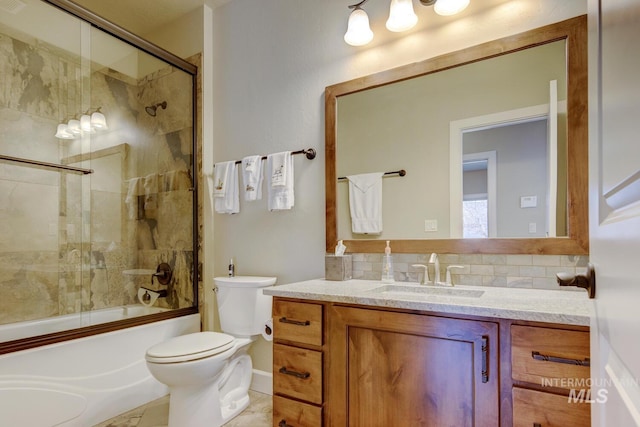 bathroom featuring toilet, tasteful backsplash, bath / shower combo with glass door, and vanity