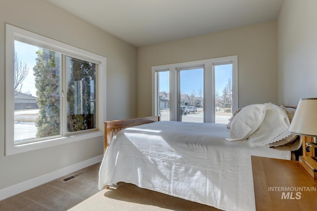 bedroom with carpet flooring, visible vents, and baseboards