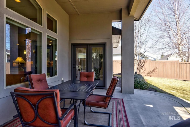 view of patio with outdoor dining space and fence