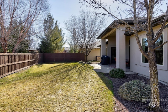 view of yard with a patio area and a fenced backyard