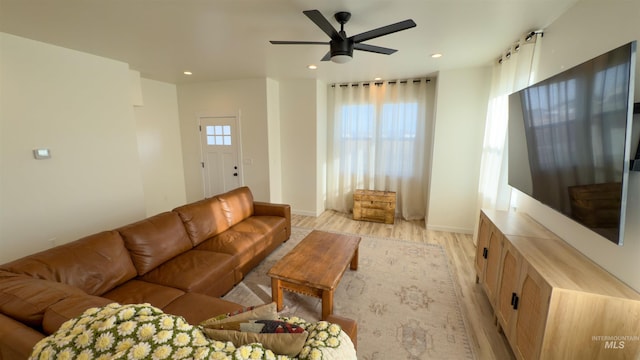 living room with light hardwood / wood-style floors and ceiling fan