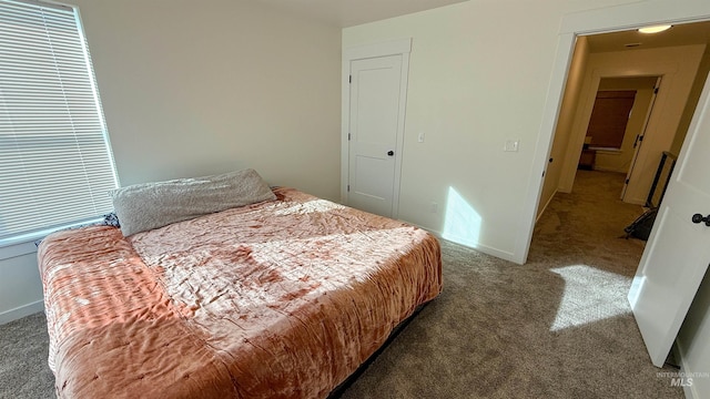 bedroom featuring dark colored carpet