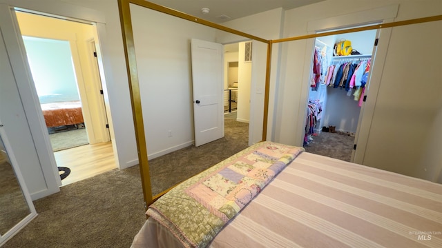 bedroom with dark colored carpet and a closet