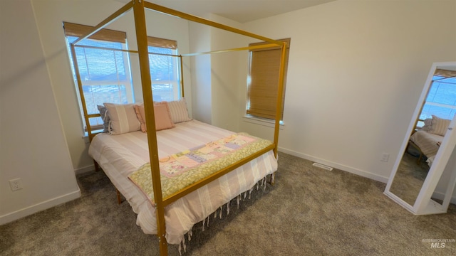 bedroom with dark colored carpet